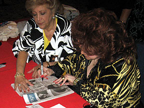 Connie autographs Feb 15 issue of Las Vegas newspaper